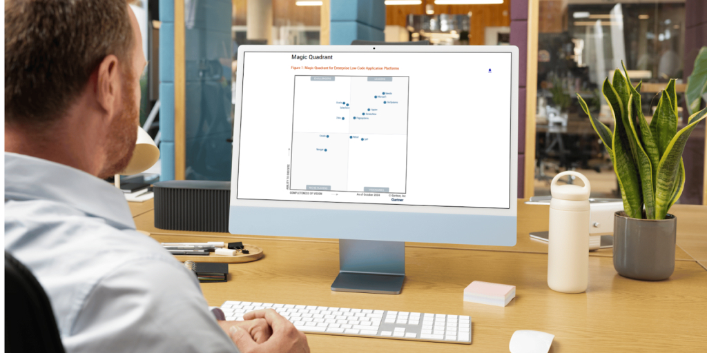 A professional man looking at his computer screen showing the Gartner Magic Quadrant report